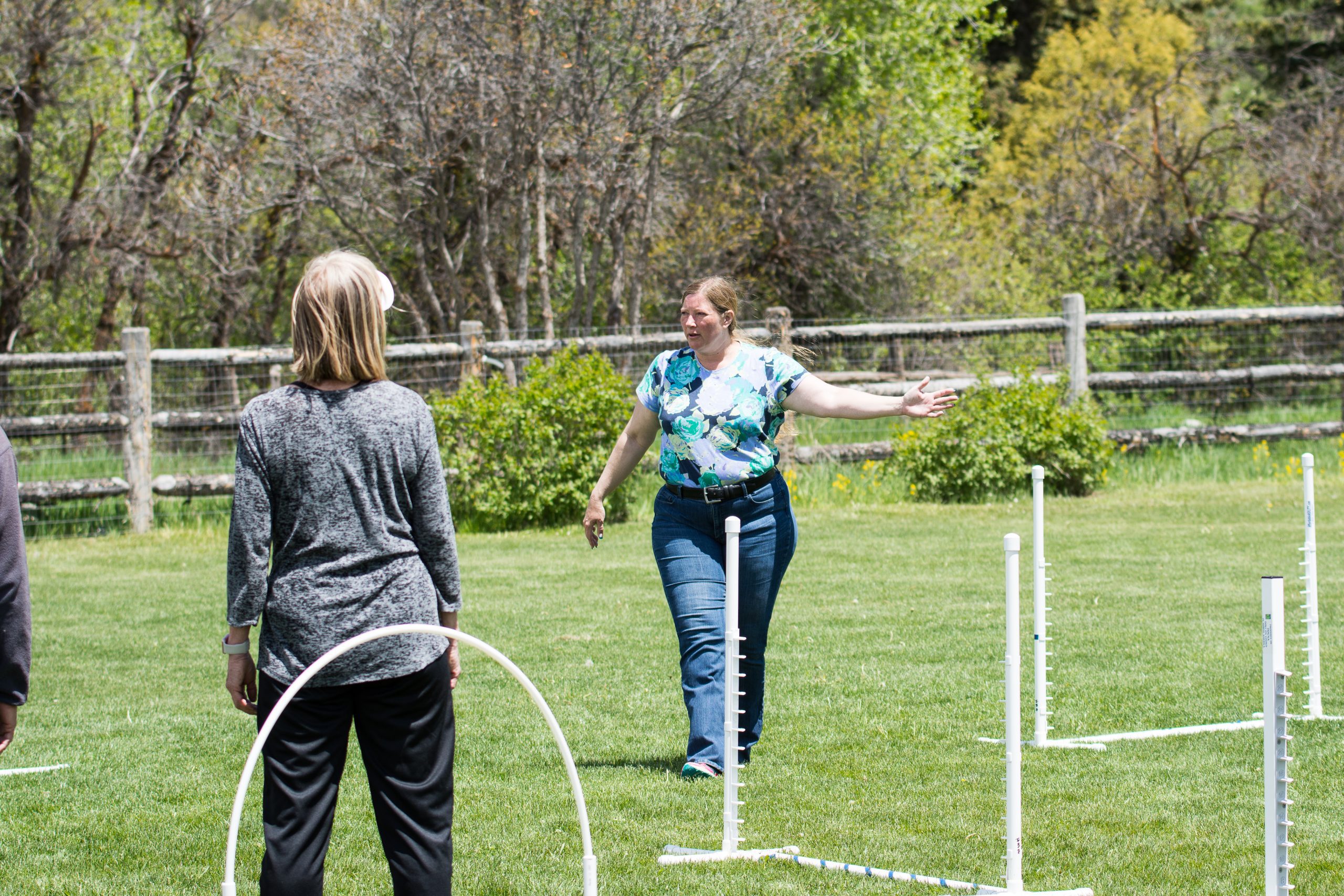 Instructor teaching agility on an outdoor field